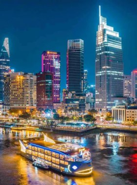 This image shows a boat tour on the Saigon River with the city skyline in the background. The clear waters reflect the modern skyscrapers and lush greenery along the riverbanks. Visitors on the boat are seen enjoying the view, while small kayaks and jet skis nearby add a dynamic touch. This lively waterway offers an exciting way to explore the city while blending scenic beauty with urban charm.