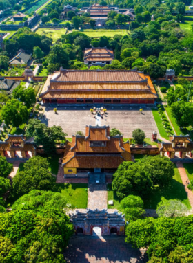 This image shows that the Imperial City in Hue is a vast UNESCO World Heritage Site surrounded by moats and walls, representing the grandeur of Vietnam’s royal history. The image highlights the ancient architecture, including intricately designed gates, temples, and halls that once housed the Nguyen Dynasty emperors. Visitors in the image are walking through expansive courtyards and pathways, showcasing the historical importance and serene atmosphere of this must-visit landmark in Hue.