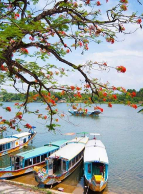 This image shows that a boat cruise along the Perfume River is a relaxing way to explore Hue’s scenic beauty. The traditional dragon boat in the image is gliding across calm waters with stunning views of green landscapes and nearby pagodas. The tranquil atmosphere reflects the charm of this experience, as visitors can enjoy breathtaking sunsets, local music, and the gentle flow of the river, making it a memorable activity in Hue.