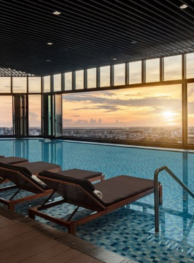 This image shows the luxurious Meliá Vinpearl Hue, a high-rise 5-star hotel in Hue offering panoramic views of the city and Perfume River. The photo features its sophisticated rooftop sky bar with elegant lighting, a serene infinity pool, and plush interiors showcasing comfort and elegance. Guests can enjoy premium services like a spa, fine dining, and business facilities. This hotel is perfect for travelers seeking modern luxury and breathtaking views during their stay in Hue.