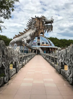 This image shows Phu Bai Adventure Park in Hue, Vietnam, featuring a high-rope obstacle course surrounded by green trees. Visitors are seen navigating challenging activities like zip-lining, climbing, and balancing on ropes. The park’s outdoor setting and adventurous vibe make it a fun and exciting destination for thrill-seekers and families with active teens.