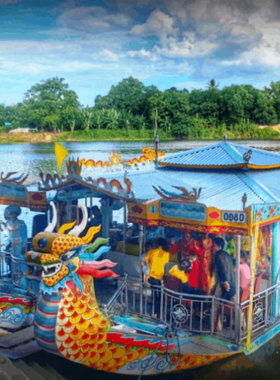 This image shows the hiking trail leading to Hon Chen Temple in Hue, Vietnam. The path is surrounded by lush greenery and offers views of the surrounding hills and Perfume River. The temple sits atop a hill, blending spiritual significance with natural beauty. Visitors can be seen enjoying the scenic journey and tranquil atmosphere, making it a perfect mix of cultural and outdoor exploration.