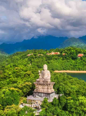 This image shows the stunning view from Bach Ma National Park, featuring lush green forests, cascading waterfalls, and a panoramic vista of the surrounding mountains. The image highlights the natural beauty and serene atmosphere of this popular destination near Hue, Vietnam. The dense vegetation and mist-covered peaks make this place a paradise for hikers and nature enthusiasts. The park is also known for its diverse flora and fauna, making it an ideal spot for wildlife photography and outdoor adventures.