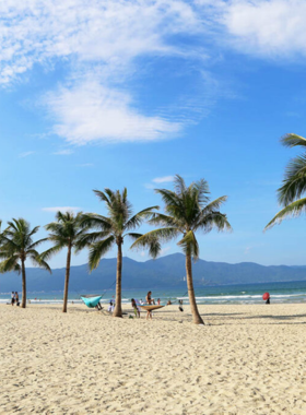  This image shows My Khe Beach in Da Nang, Vietnam. The beach features soft golden sand, clear blue waters, and people relaxing, swimming, or enjoying water sports like jet skiing and parasailing. The atmosphere is vibrant yet peaceful, with a beautiful view of the horizon. It's a popular destination for both locals and tourists, offering a perfect escape to enjoy the sun and sea. This image captures the serene yet active vibe of My Khe Beach, ideal for beach lovers and adventure seekers.