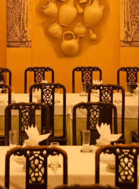 This image shows Apsara Restaurant, a cultural dining spot in Da Nang with traditional Vietnamese décor and live performances. The restaurant is adorned with intricate wooden carvings, lanterns, and traditional art pieces, creating a warm and immersive experience. Diners can enjoy dishes like banana flower salad while appreciating the vibrant cultural dance shows, which enhance the rich heritage vibe of this iconic dining venue.