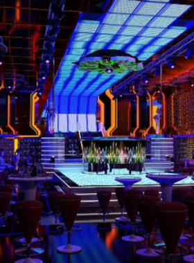 This image shows the vibrant OQ Lounge Pub in Da Nang, featuring a lively ambiance with live music performances. The setting includes comfortable seating, colorful lights, and a stage where musicians entertain the guests. The atmosphere is energetic, with people enjoying their drinks, mingling, and immersing themselves in the music. OQ Lounge is the perfect spot for those who love to combine great music with a modern and welcoming nightlife experience.