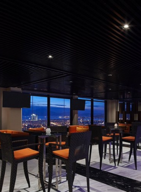 This image shows Horizon Rooftop Bar, a sophisticated rooftop venue in Da Nang. The bar features elegant seating and offers breathtaking views of the city skyline and ocean. Guests are seen sipping on cocktails and enjoying the peaceful yet luxurious setting. The ambient lighting and panoramic scenery create a relaxing vibe, making Horizon Rooftop Bar the perfect destination for those seeking a memorable evening above the bustling city.