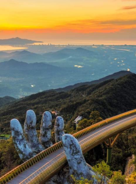 This image shows the stunning Golden Bridge at Ba Na Hills, held up by giant stone hands. The breathtaking view from the bridge captures the surrounding mountains and cool, misty air of the hill station. The image also highlights the French village, gardens, and amusement park at the top, offering visitors a combination of natural beauty, architecture, and fun attractions. Ba Na Hills is a must-visit destination that blends adventure, leisure, and stunning views, making it an unforgettable experience.