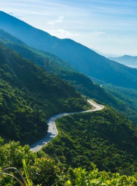 This image shows the stunning views from Hai Van Pass, one of Vietnam’s most scenic roads. The winding curves of the road offer breathtaking views of the ocean and mountains, making it a thrilling journey for travelers. The image captures the beauty of the pass, with scenic spots perfect for taking photos and relaxing. Whether driving or riding a motorbike, the Hai Van Pass provides an unforgettable adventure with its serene charm and picturesque landscapes.