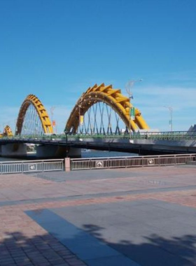 This image shows the peaceful atmosphere of Cau Do Bridge, offering beautiful views of the Han River and Da Nang cityscape during sunset. The image captures the calm vibe of the bridge, making it a perfect spot for evening walks or taking stunning photographs. The quiet setting contrasts with the busy Dragon Bridge, making it a hidden gem for those seeking a more relaxed and tranquil spot to enjoy the beauty of Da Nang’s riverfront.