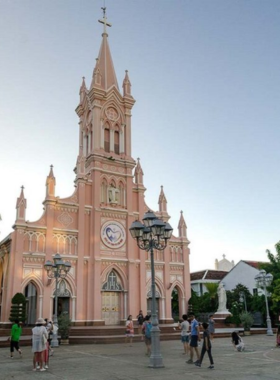 This image shows the charming pink Da Nang Cathedral, also known as the "Rooster Church" for its weather vane. The Gothic-style architecture and serene interior make it one of the oldest and most significant churches in Da Nang. The image highlights the cathedral’s historical charm and its peaceful atmosphere, offering visitors a chance to step back into the city’s colonial past. It’s a perfect stop for anyone interested in Da Nang’s cultural and architectural heritage.