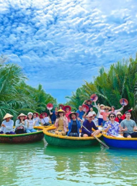 This image shows the unique basket boat ride in the Water Coconut Forest near Hoi An. Locals guide the round bamboo boats through narrow waterways surrounded by dense greenery. A group of tourists looks excited as they experience this fun and cultural activity. The image highlights the traditional Vietnamese fishing technique and the natural beauty of the forest. This adventure combines thrilling spins, cultural performances, and serene exploration, offering an unforgettable experience.