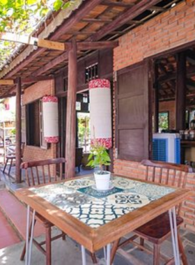 This image shows Rosie’s Café in Hoi An, a trendy and Instagram-worthy café perfect for breakfast or brunch. With a menu featuring smoothie bowls, French toast, and avocado toast, Rosie’s Café offers healthy, delicious options in a beautiful setting. The warm wooden interiors and plant-filled space provide a cozy environment for guests to unwind and enjoy their meal. Whether you're catching up on emails or enjoying a leisurely breakfast, Rosie’s Café is the ideal place to start your day in Hoi An.