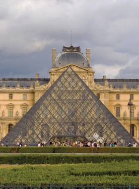 This image shows the stunning interior of the Louvre Museum, with its grand glass pyramid and vast collection of art and history. The Louvre is one of the largest and most visited museums in the world, featuring masterpieces like the Mona Lisa and the Venus de Milo. The museum’s architecture blends modern glass structures with classical buildings, creating a striking visual experience. Visitors can explore a variety of art from different cultures and periods inside this historic institution.