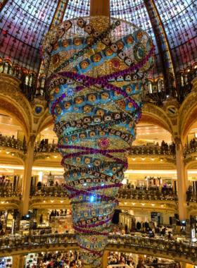 This image shows the rooftop terrace of Galeries Lafayette, offering an incredible panoramic view of Paris. The department store’s stunning architecture is visible in the foreground, with the Eiffel Tower and other Parisian landmarks in the background. Galeries Lafayette is a luxury shopping destination, featuring a variety of high-end brands and designer goods. The rooftop is a popular spot for visitors to relax and take in the sweeping views of the city, making it a perfect blend of shopping and sightseeing.