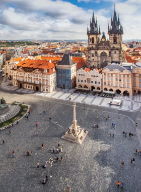 This image shows Prague’s Old Town Square, a bustling hub filled with medieval charm. The Gothic-style Church of Our Lady before Týn rises majestically against the sky, surrounded by cobblestone streets and vibrant street performers. Visitors gather to admire the intricate details of the Astronomical Clock and enjoy the lively atmosphere of nearby restaurants and markets.