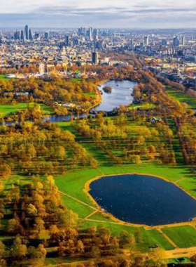 This image shows the peaceful scenery of Hyde Park, one of London’s largest and most famous parks. Known for its vast green spaces, Hyde Park is the perfect place to relax, take a walk, or have a picnic. The park is home to beautiful gardens, the Serpentine lake, and open-air events, making it a popular spot for locals and tourists alike. It offers a serene escape from the bustling city, providing a natural oasis in the heart of London.