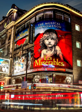 This image shows a lively West End theater performance in London, showcasing the city’s world-renowned theater scene. The West End is home to some of the best musicals and plays, attracting theatergoers from all over the world. Whether it's a classic show like "Les Misérables" or a brand-new production, visitors can enjoy top-quality performances in grand venues. London’s West End offers an unforgettable cultural experience for those who love the arts and entertainment.