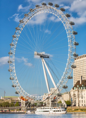 This image shows the London Eye, a giant observation wheel offering stunning panoramic views of the city. Situated on the South Bank of the River Thames, it allows visitors to see iconic landmarks like Big Ben, the Houses of Parliament, and St. Paul’s Cathedral from high above. The glass capsules give a 360-degree view of the city, making it an ideal spot for photography, especially during sunset or at night when London’s lights shine brightly.