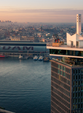 This image shows the A’DAM Lookout Tower in Amsterdam, offering a stunning 360-degree view of the city. The tower’s rooftop features Europe’s highest swing, where brave visitors can swing over the edge at 100 meters above ground. For those not keen on heights, the rooftop also provides panoramic views of Amsterdam, making it a perfect spot to relax and enjoy a cocktail. It’s a thrilling experience for adventure seekers and a great photo opportunity for everyone.