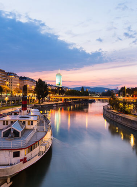 This image shows a scenic Danube River cruise in Vienna, offering breathtaking views of the city's skyline and landmarks. The river cruises are a great way to explore Vienna from a different perspective, whether you’re enjoying a peaceful day ride or a romantic evening dinner cruise. Along the way, you’ll pass charming waterfront views, historical sites, and natural beauty. A river cruise provides a relaxing and memorable experience during your visit to Vienna.