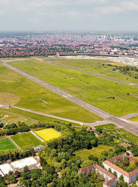 This image shows Tempelhofer Feld, a vast public park in Berlin, once a functioning airport. It’s now one of the largest parks in the city, offering plenty of space for activities such as cycling, kite-flying, or simply relaxing on the grass. The park’s historical connection to aviation adds a unique character to the place. It’s an excellent spot for outdoor enthusiasts and those looking to enjoy Berlin’s fresh air and open space.