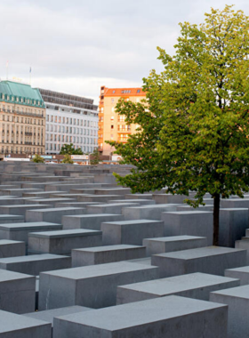 This image shows the Holocaust Memorial, officially known as the Memorial to the Murdered Jews of Europe. This solemn site features 2,711 concrete slabs, creating a maze-like atmosphere designed to evoke reflection and remembrance. The memorial honors the victims of the Holocaust, offering visitors a chance to reflect on the tragedies of the past and gain a deeper understanding of the historical significance of this painful chapter in history.