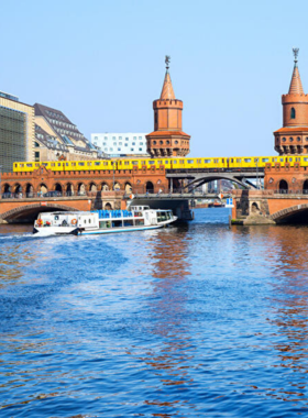 This image shows a relaxing boat tour along the Spree River, offering a different perspective of Berlin. As the boat cruises along the river, passengers are treated to views of the city’s stunning architecture, modern landmarks, and lush green spaces. The boat tour provides an excellent opportunity to see Berlin from the water, offering beautiful views and an enjoyable way to take in the city’s rich history and vibrant atmosphere.