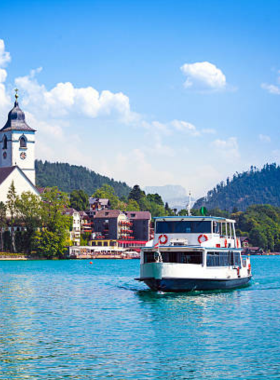 This image shows a peaceful boat ride on Lake Wolfgang, one of Austria’s most beautiful lakes. Surrounded by picturesque mountain views and small charming towns, the lake offers a relaxing escape into nature. Whether you’re taking in the view from the boat or visiting lakeside villages like St. Gilgen, the boat ride provides a serene experience with breathtaking landscapes and crystal-clear waters, making it a perfect leisurely activity in Austria.