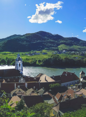 This image shows the picturesque Wachau Valley, a UNESCO World Heritage site located along the Danube River in Austria. The valley is known for its rolling vineyards, charming towns like Dürnstein, and historic castles. Visitors can enjoy scenic boat tours, bike rides, or wine tastings while exploring the area. The breathtaking landscapes, combined with the region’s rich history and culture, make Wachau Valley a perfect destination for nature lovers and history buffs alike.