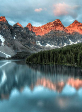 This image shows a scenic hiking trail in the Canadian Rockies, surrounded by towering mountain peaks, lush forests, and alpine lakes. The rugged trails lead adventurers to breathtaking viewpoints where they can see glaciers and valleys stretching for miles. The area is home to various wildlife, including deer, bears, and eagles. Hikers often camp overnight to experience the beauty of the stars shining above the mountains. The fresh mountain air and peaceful surroundings make it a perfect place for nature lovers and outdoor enthusiasts.