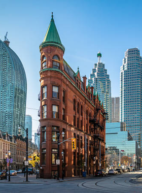 This image shows Toronto’s vibrant skyline at night, with the CN Tower glowing brightly. The city streets are filled with people walking, shopping, and enjoying restaurants. Skyscrapers line the roads, showcasing Toronto’s modern and diverse culture. Streetcars pass by as neon lights reflect on the pavement. Different districts offer unique experiences, from the Distillery District’s historic charm to Kensington Market’s artistic vibe. The mix of cultures, foods, and entertainment options makes Toronto an exciting place to visit any time of the year.