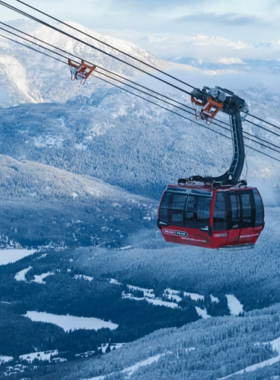 This image shows the stunning Whistler Blackcomb ski resort in British Columbia, Canada, covered in a thick layer of snow. The slopes stretch for miles, with skiers and snowboarders gliding down the mountain at different skill levels. The chairlifts transport visitors to the top, offering breathtaking panoramic views of the surrounding peaks. Cozy lodges sit at the base, providing warm drinks and delicious meals after a thrilling day on the slopes. The sky is a bright blue, contrasting beautifully with the white snow. Whistler Blackcomb is one of the most famous winter sports destinations in the world, attracting adventure seekers from around the globe. The lively village below is filled with restaurants, shops, and entertainment, making it a perfect destination for both relaxation and action-packed fun. Whether you’re an expert or a beginner, this resort offers an unforgettable skiing experience with world-class facilities and beautiful scenery.