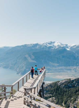 This image shows Whistler, a world-famous mountain resort near Vancouver. The snow-covered peaks are perfect for skiing, while in summer, visitors enjoy hiking and mountain biking. The cozy Whistler Village is visible, filled with charming lodges, shops, and restaurants. The scenic drive along the Sea-to-Sky Highway leading to Whistler offers breathtaking views, making it an ideal day-trip destination for adventure seekers and nature lovers.