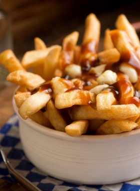 This image shows a delicious spread of Quebecois cuisine, including classic dishes like poutine, tourtière, and maple syrup treats. Quebec City’s food scene is famous for its hearty, flavorful dishes, often featuring local ingredients like potatoes, meats, and maple products. Visitors can enjoy these comforting meals in cozy restaurants or casual bistros, making it an essential part of the Quebec City experience. Don’t miss out on the local flavors during your visit!