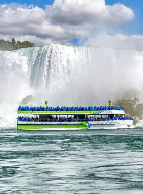 This image shows the Maid of the Mist boat taking tourists close to the Niagara Falls, providing an unforgettable experience with mist from the falls splashing over the boat. The boat ride gives visitors a chance to witness the power and beauty of the falls up close, with people wearing blue rain ponchos for protection from the spray of water. It’s a thrilling and iconic experience that offers stunning views of one of the world's most famous natural landmarks.