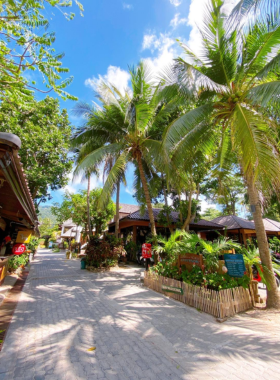 This image shows the eco-friendly rooms at Nature Resort Koh Tao, set amidst lush gardens. The resort emphasizes sustainability with organic food, nature trails, and a relaxing spa, providing a nature-filled getaway for eco-conscious travelers.