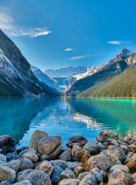 This image shows the iconic Lake Louise, a stunning turquoise lake surrounded by majestic mountains in Banff National Park. The lake’s crystal-clear waters reflect the towering snow-capped peaks, creating a breathtaking view. Visitors can enjoy walking around the lake’s shore or take part in seasonal activities such as canoeing in the summer or ice skating in the winter. The beautiful Fairmont Chateau provides a scenic place to relax and enjoy the surrounding natural beauty. This image shows that Lake Louise is a must-visit destination for nature lovers and adventure seekers alike.