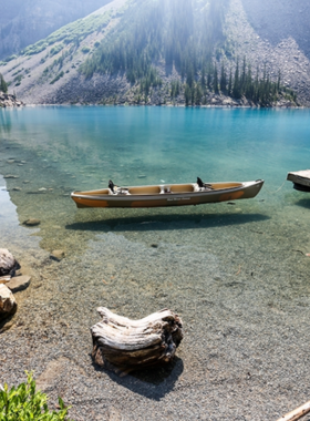 This image shows the stunning Moraine Lake, located in the heart of Banff National Park. Surrounded by rugged mountains and lush forests, the lake's vibrant blue water is one of the most striking features of the area. The lake is a popular spot for photography, hiking, and canoeing in summer. The beauty of Moraine Lake is a testament to the stunning natural landscapes that Banff offers. This image shows that Moraine Lake is an unforgettable and must-see destination for nature lovers.