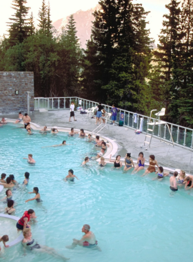 This image shows visitors enjoying a peaceful soak in the Banff Upper Hot Springs, surrounded by snow-covered mountains. The naturally heated mineral waters offer a relaxing and rejuvenating experience while providing stunning views of the surrounding peaks. After a long day of exploring, the hot springs are the perfect way to unwind and embrace the beauty of the Canadian Rockies. This image shows that Banff Upper Hot Springs is a serene spot to relax and soak in the area’s natural beauty.