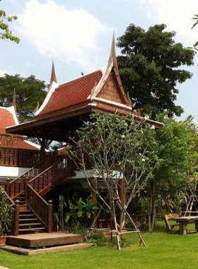 This image shows Baan Thai House, a traditional guesthouse offering a cozy and homely atmosphere. Surrounded by beautiful gardens, it provides a warm, authentic Thai experience with comfortable rooms and warm hospitality.