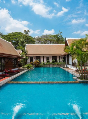 This image shows Ancient Sukhothai Resort, a family-friendly, sustainable resort. It features spacious rooms, a beautiful outdoor pool, and a serene environment, perfect for families looking for comfort and relaxation in nature.