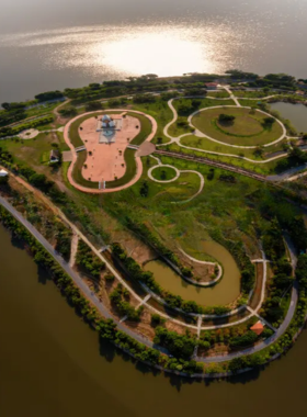 This image shows a serene walk on Thung Talay Luang Reservoir Island, surrounded by the calm waters and lush landscapes, offering a tranquil retreat into nature and a perfect escape from the busy city.