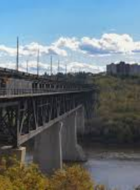 This image shows the High Level Bridge in Edmonton, a historic landmark that spans the North Saskatchewan River. The bridge offers stunning views of Edmonton’s downtown skyline and the river valley. Visitors can walk across the pedestrian path to take in the panoramic scenery or enjoy a scenic drive. The High Level Bridge is a great spot for photography, offering beautiful views of the city from a unique perspective."