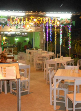 This image shows a table at Baitong Thai Food Restaurant, showcasing a variety of stunning curry dishes. Each dish is presented in traditional Thai bowls with vibrant garnishes. The simple yet comfortable seating adds to the homely atmosphere, while the quality of food emphasizes the restaurant's reputation for excellent value. The image captures the essence of authentic Thai dining in Sukhothai.