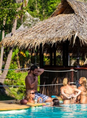 This image shows the rooftop ambiance at Serve Chilled Roof Garden, with stunning views of Koh Tao's skyline and lush greenery. Guests are seen sipping cocktails and enjoying the peaceful, elevated setting.