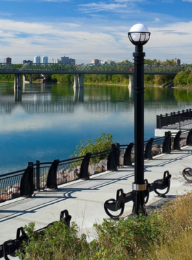 This image shows a scenic view of Edmonton's River Valley, North America's largest urban park system. The park offers miles of hiking and biking trails that wind through lush forests and along the riverbanks. It’s a beautiful place to explore nature within the city, offering peace and quiet for outdoor lovers. Visitors can enjoy activities like cycling, hiking, kayaking, or just relaxing in the serene natural surroundings."