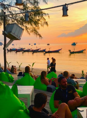 This image shows the relaxed beachfront setting of Chill Beach Bar, where guests enjoy refreshing cocktails while admiring the ocean view. The laid-back vibe and serene surroundings make it an ideal place to unwind.