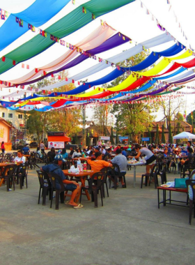 This image shows the lively Chiang Rai Walking Street Night Market, bustling with people shopping for handmade goods, enjoying local street food, and experiencing Thai culture. The market is filled with vibrant colors and music, making it a fun and authentic experience.