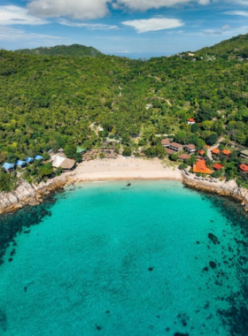 This image shows the breathtaking view from Ao Leuk Viewpoint, overlooking the turquoise waters and sandy beach below. The photo captures the lush green vegetation and a winding path leading to the viewpoint. The serene and quiet surroundings make it a perfect spot for photography and relaxation.